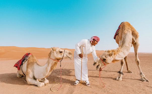 OMN/Sharqiya Sands/Desert Nights Camp - Omani mit Kamelen
